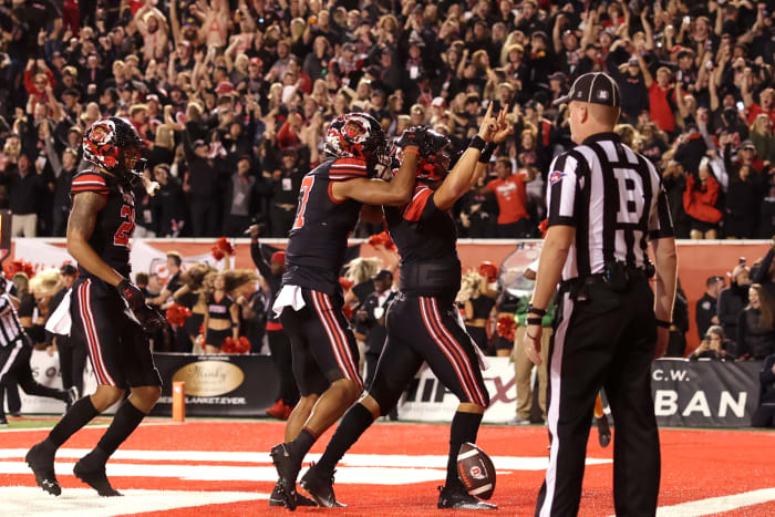 Utah Utes quarterback Cameron Rising (7) celebrates scoring a two-point conversation to take a one point lead against the USC Trojans in the final minute of the game at Rice-Eccles Stadium.
